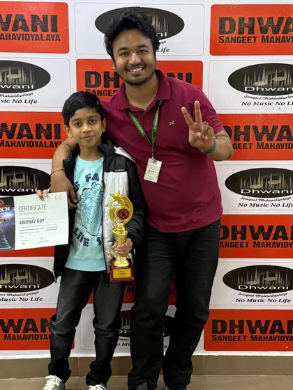A proud moment for the Dhwani family. Here is our student Abhinav Roy with his teacher after winning the Radio Mirchi Spardha Idol, a national competition. We don't just teach music; we build performers who achieve excellence on grand stages.
