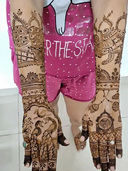 A full-coverage design featuring traditional Indian figures like peacocks and paisleys, extending all the way up the arm for a grand statement.