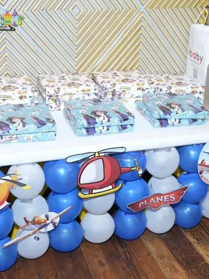 A beautifully arranged table of return gifts for a 'Planes' themed party.