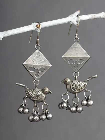 These charming oxidized silver earrings feature a bird motif with dangling ghungroos. They are playful, unique, and full of character.