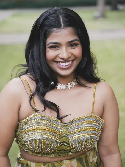 A big, beautiful smile. The makeup is fresh and radiant, perfect for a daytime Mehendi party.