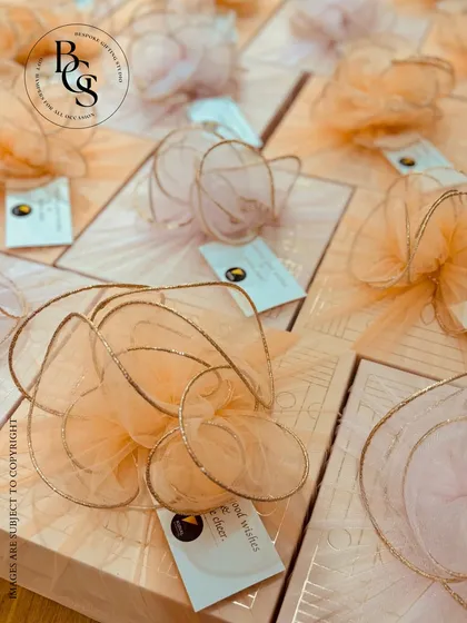 A close-up of our elegant peach-toned Diwali gift boxes. The soft color palette is complemented by delicate, airy tulle bows and custom tags, offering a subtle and sophisticated take on festive gifting.
