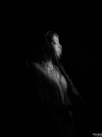 An abstract, motion-blur portrait of the bride in black and white, creating an artistic and mysterious feel.