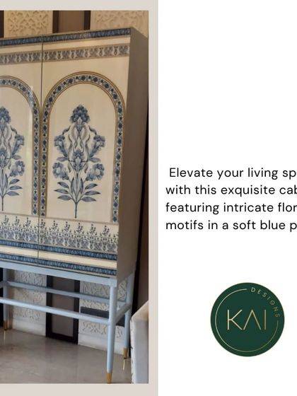 This exquisite cabinet features intricate floral motifs in a soft blue palette, reminiscent of traditional block printing. Set on a simple, modern base, it's a piece of art that provides functional storage.