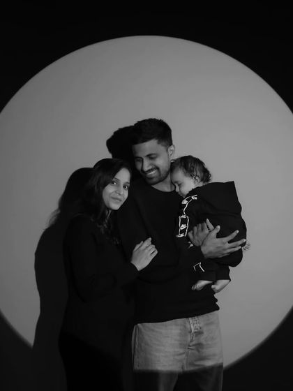 The same modern family portrait, presented in timeless black and white. This version emphasizes the emotion and connection within the family, creating a powerful and artistic image.