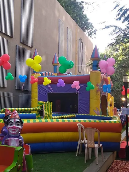 A vibrant party setup showing a classic castle bouncer in a garden venue. I can arrange multiple attractions to fit your event space.