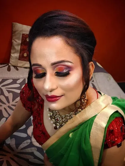 A close-up of the creative eye makeup, with a blend of red, orange, and gold.