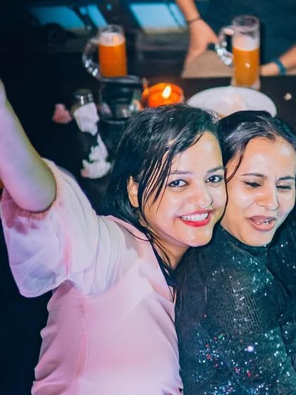 Two friends dancing together, a candid moment of joy.