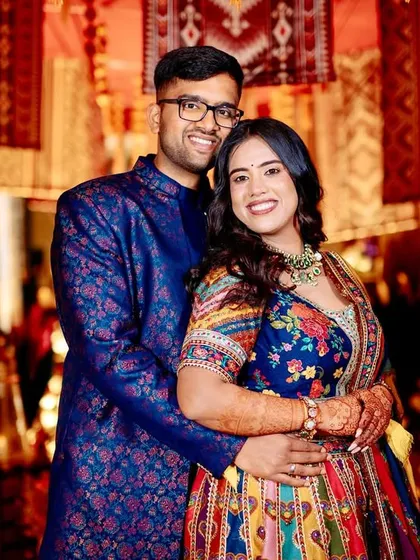 A happy portrait of the couple, their smiles as bright as the colorful and festive decor surrounding them.