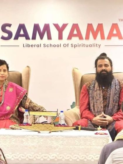 We are seated before an audience during a spiritual retreat in Kashmir. This image captures the intimate setting of our retreats, where participants can engage in deep spiritual learning and meditation in a serene environment.