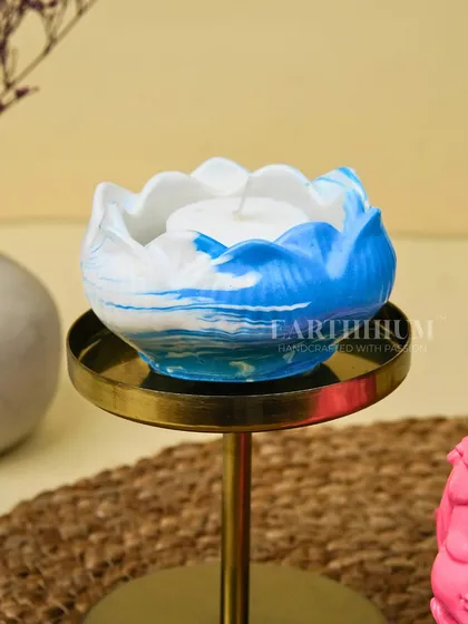 A close-up of the blue and white marbled lotus tea-light holder. The pattern mimics the look of natural stone or ocean waves.