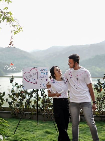 A candid shot from the same paint session, capturing the couple's joy against a beautiful natural backdrop.