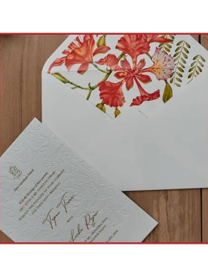 The beauty of this design lies in its understated elegance. We used a blind letterpress technique to emboss the outline of Gulmohar flowers onto the card, paired with an envelope liner featuring the same flower in full color. This creates a subtle, tactile experience that is both modern and timeless.