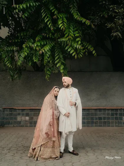 A quiet moment of togetherness. For this Anand Karaj ceremony, we chose a soft, layered pastel lehenga for the bride and a classic, understated sherwani for the groom, creating a look of serene, modern grace.