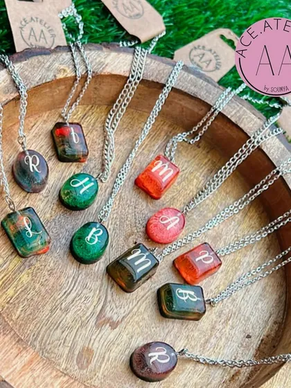 Elegance is in the details. This image showcases my collection of signature initial pendants, each with a unique color blend, ready to become your new favorite accessory.