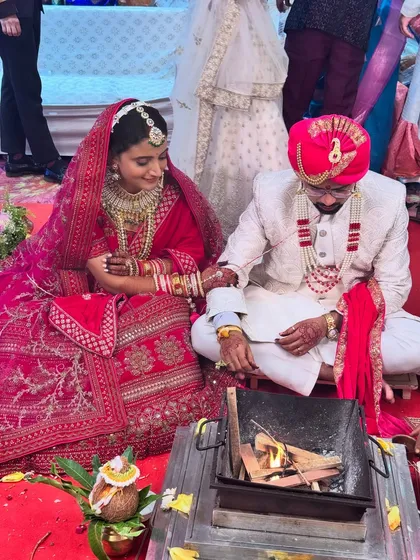 A beautiful shot of the bride and groom during the wedding rituals. The bride's makeup is flawless even in the candid moments of the ceremony.