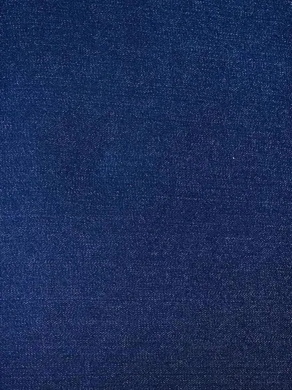 A deep indigo denim swatch. This is the foundation for classic raw denim jeans that will fade and develop character uniquely to you as you wear them.
