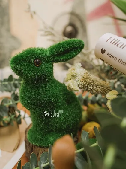 A detailed shot of a moss-covered rabbit figurine, a small but charming element of the woodland theme.