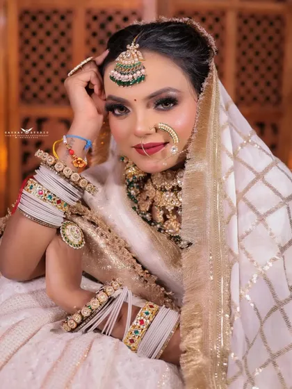 A charming close-up of the bride, her head tilted, showcasing her smile and the details of her bangles.