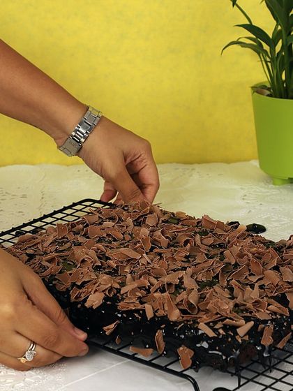 Here I am, adding the final touch of chocolate shavings to my special Paan brownies. The hidden layer of paan gives it an extraordinary taste.