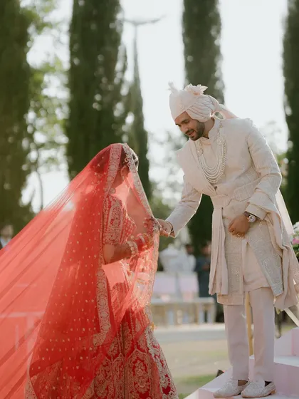 The groom lifts the bride's veil, a tender and timeless moment before they officially become husband and wife. I ensure the photographers are positioned to capture these subtle, emotional interactions.