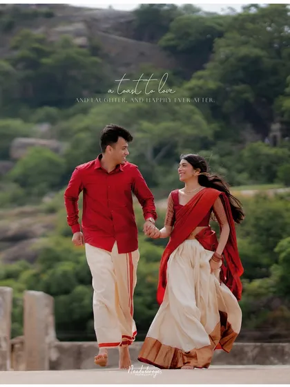 A joyful shot of a couple running hand-in-hand, their traditional outfits in motion against a natural backdrop.