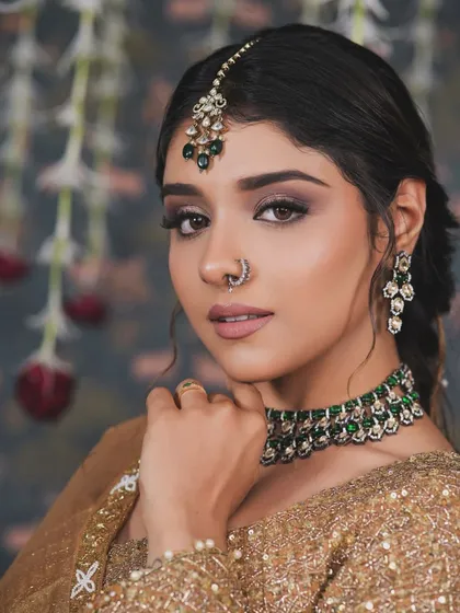 A stunning portrait of this bride-to-be. The soft smokey eye and nude lip are perfectly balanced, letting her natural beauty and the gorgeous green jewelry take center stage.