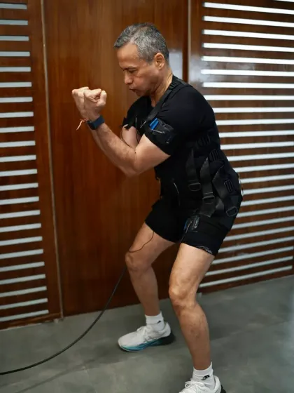 Another angle of the squat, highlighting the deep muscle activation in the legs and glutes, which is enhanced by the electrical impulses.