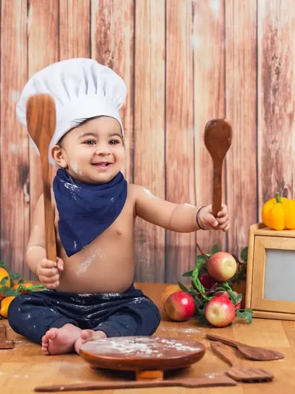 This little chef is having a blast with his oversized wooden spoons. The smiles are always genuine when they get to play.