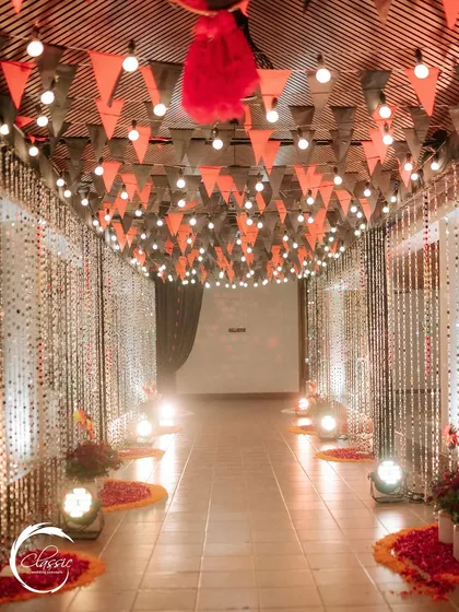 The view down this decorated corridor, with spotlights illuminating the path and creating a dramatic effect. The design guides the eye and builds a sense of occasion.