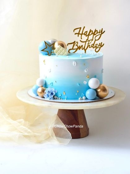 A centered shot of the blue ombre cake, showing the "Happy Birthday" topper.