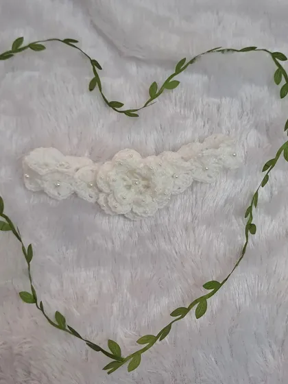 A simple and beautiful crochet headband. The white floral design is timeless, and the piece is framed by a heart-shaped vine to show it's made with love.