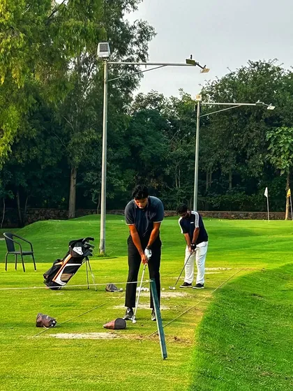 Two golfers share a bay, offering tips and encouragement. This is what our community is all about.