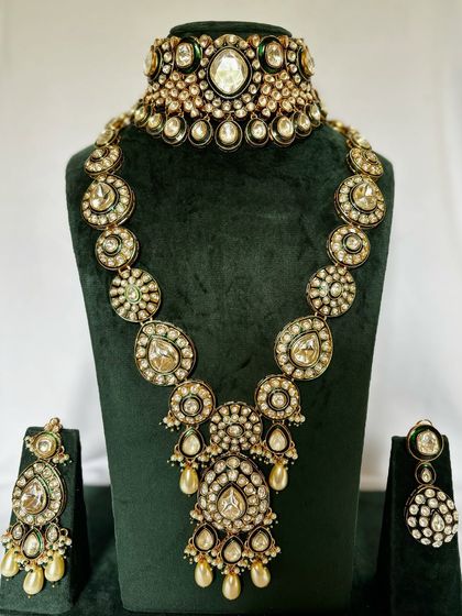 A classic Rani Haar and choker combination set for rent. The design features large Polki stones and pearl drops for an elegant bridal look.
