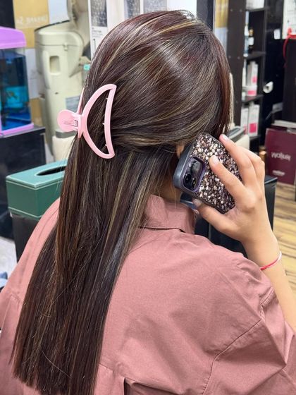 A stylish half-up look showing off the sleek texture and contrasting Ash Blonde highlights achieved with our Botoliss treatment.