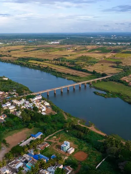 A bridge connects two banks of a river in rural Karnataka. A simple, beautiful scene of life in the countryside.