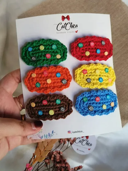 Holding up the full set of six 'Girly Gems' clips. You can see all the vibrant colors in this fun, candy-inspired collection.