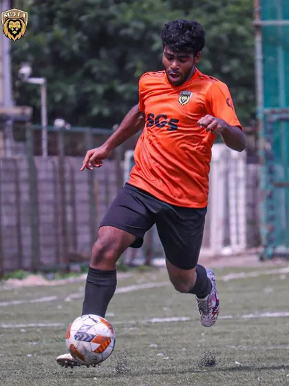 A player in full stride, dribbling the ball up the field with speed and control.