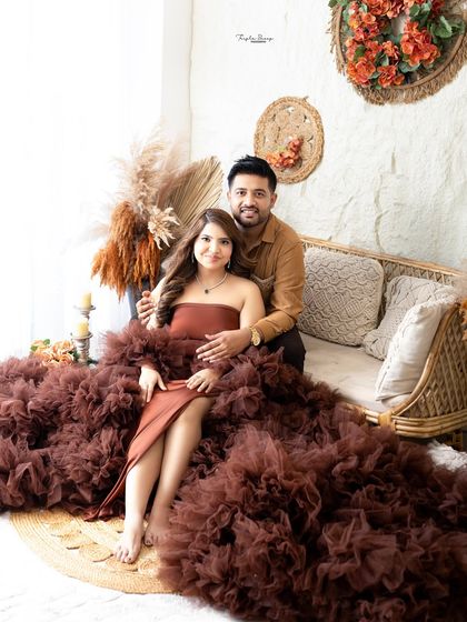 A relaxed family portrait on the studio floor. This casual posing feels natural and brings everyone close together for an intimate shot.
