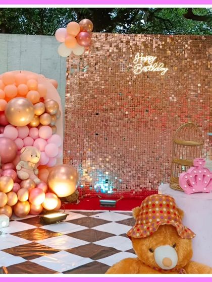 A teddy bear-themed first birthday with a rose gold sequin wall and a checkered floor.