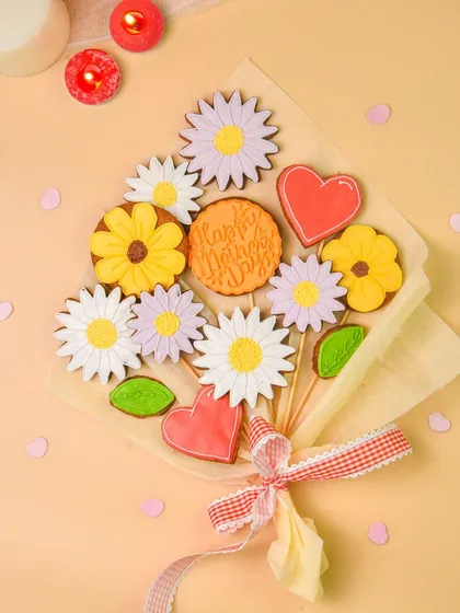 A creative and beautiful cookie bouquet with flower and heart-shaped decorated cookies, perfect for a bakery's special occasion offerings.