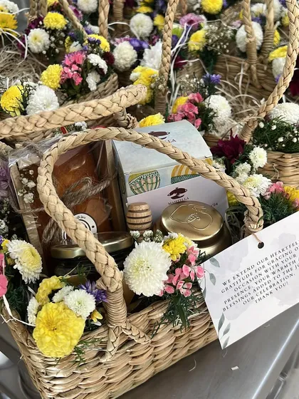 A close-up of the housewarming return favors I created. These little baskets, filled with honey and other treats, are a sweet way to show your gratitude.