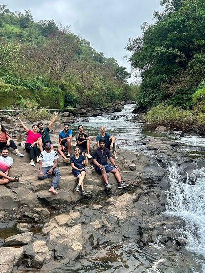 The group relaxing on the rocks by a river, taking a break during one of our treks in the beautiful landscapes of Maharashtra.