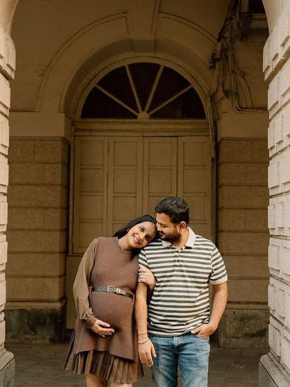Nestled in the beautiful old arches of Mumbai, this shot feels like a timeless love story. The architecture adds a touch of classic romance to their maternity portraits.
