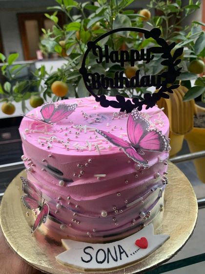 A pretty pink ombre cake with butterflies, perfect for a birthday.