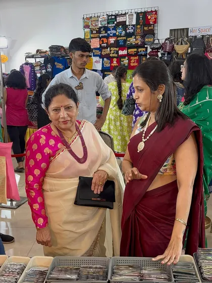 A candid moment of interaction with a customer browsing through the collection of magnets and mini frames at my stall.