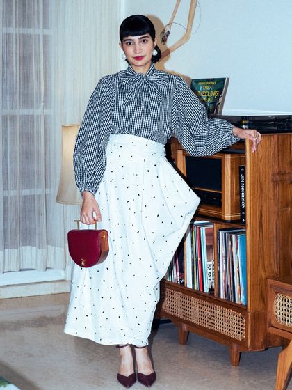 For a GQ Christmas event, I styled this checkered pussy-bow blouse with an asymmetrical skirt for a classic yet modern look.