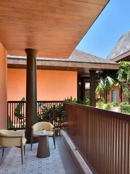 Step out onto your private balcony to enjoy a quiet morning coffee or an evening chat. The space is furnished for your comfort, offering a personal connection to the resort's serene landscape.