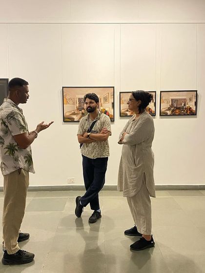 Artist Pushpamala N. visiting Sandeep TK's exhibition and engaging in conversation with the artist.