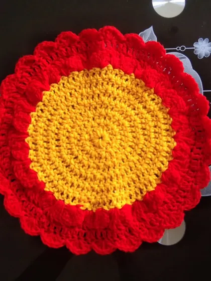 Another round table mat design in yellow and red.